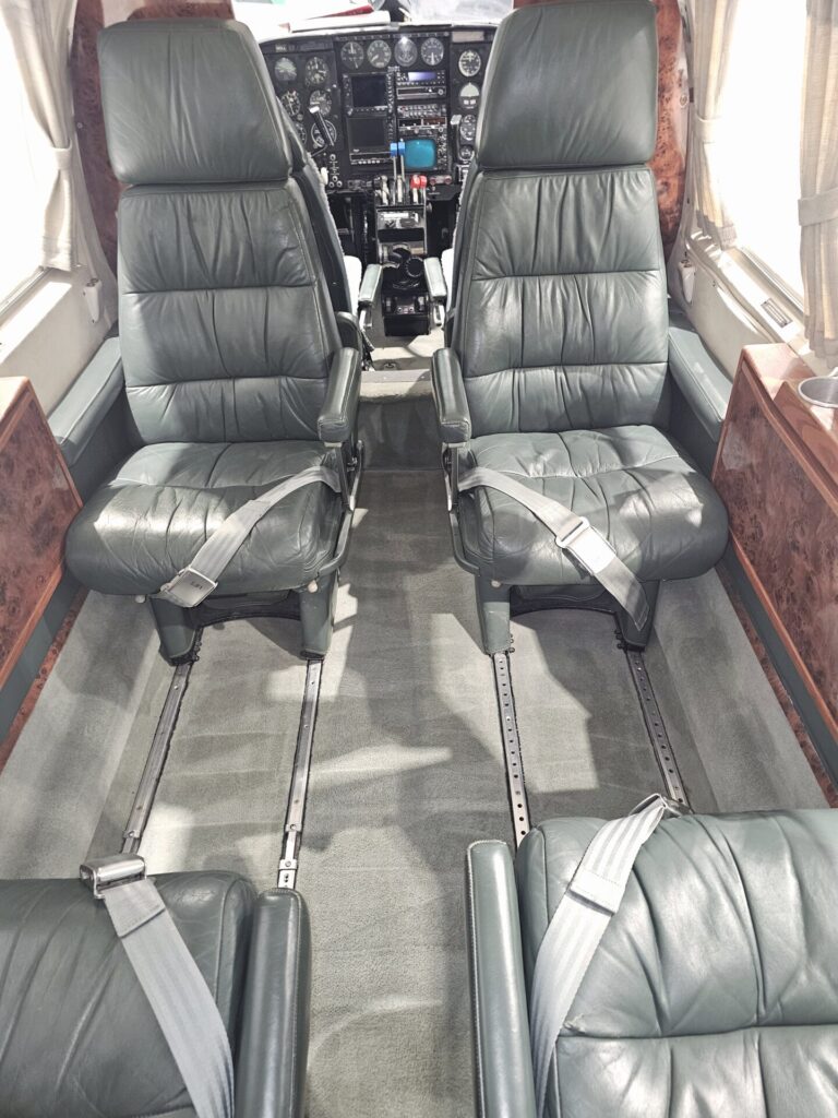 Piper Navajo aircraft interior deep cleaning, including hot water carpet extraction, leather upholstery cleaning and treatment, and wood polishing.